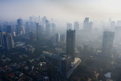 High angle view of modern buildings in city against sky