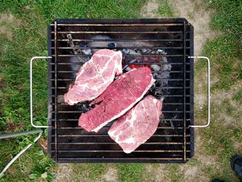 High angle view of meat on barbecue grill