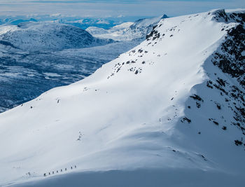 Scenic view of snow covered mountains against sky