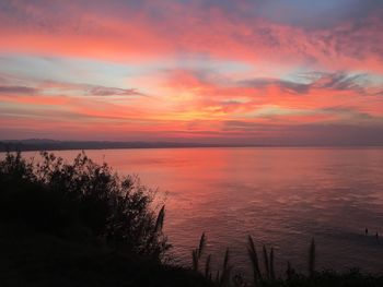 Scenic view of sea against romantic sky at sunset