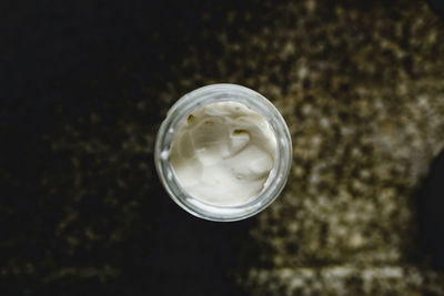 High angle view of mayonnaise in jar on table