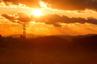 Scenic view of silhouette mountains against sky during sunset