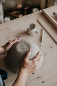 Midsection of woman at pottery workshop