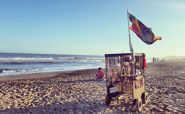 beach, sea, horizon over water, sand, shore, water, clear sky, beach umbrella, vacations, flag, parasol, sky, tranquility, copy space, incidental people, scenics, tranquil scene, summer, large group of people, nature