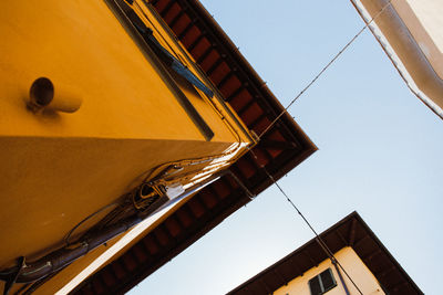 Low angle view of yellow building against clear sky