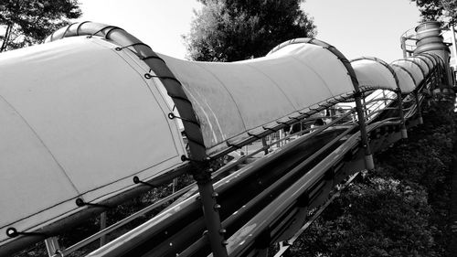 Low angle view of trains on field against sky