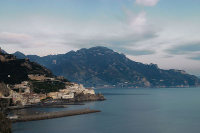 Scenic view of sea by city against sky