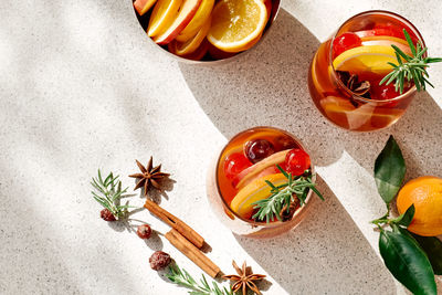 Mulled wine or christmas sangria with aromatic spices, apple, cherry and citrus fruits.