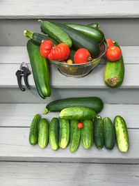 High angle view of tomatoes, zucchini and cucumbers on table