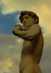 Midsection of man on beach against sky