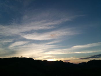 Scenic view of silhouette landscape against sky at sunset