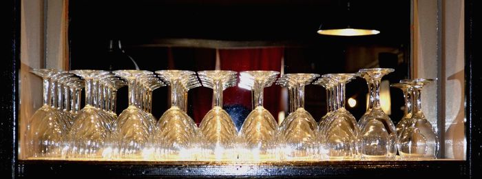 Candles in glass container on table