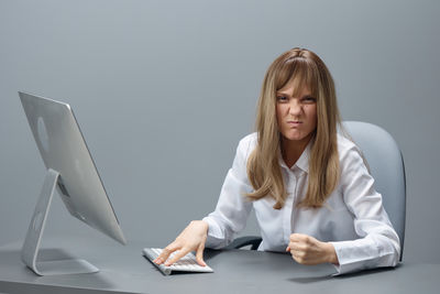 Portrait of young woman using laptop at home