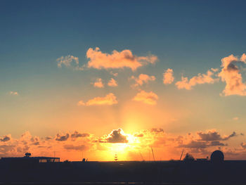 Scenic view of silhouette building against sky during sunset