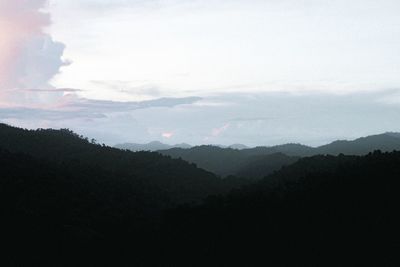 Scenic view of silhouette mountains against sky