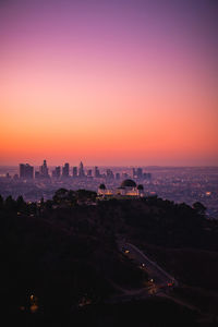 Cityscape against clear sky during sunset