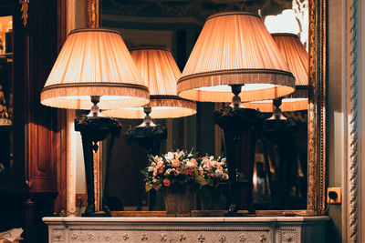 Close-up of illuminated lamp on table at home