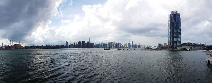 Panoramic view of sea and buildings against sky