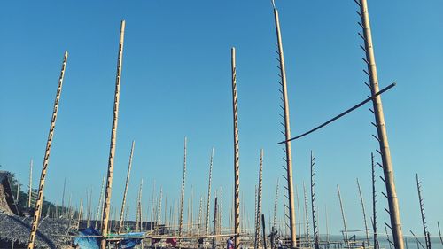 Low angle view of sailboats against clear blue sky