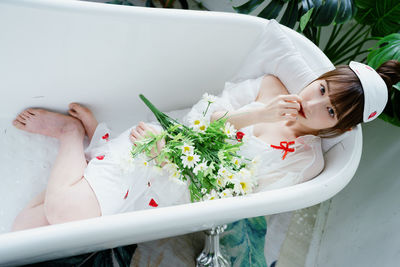 High angle view of young woman sitting on table