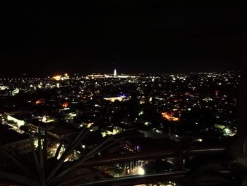 Illuminated city against sky at night