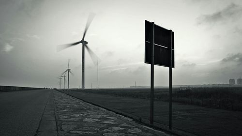 Empty road against cloudy sky