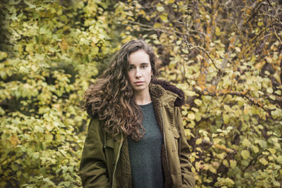 Portrait of a beautiful young woman standing in winter