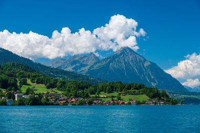 Scenic view of sea and mountains against sky