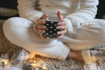 Midsection of woman holding mug