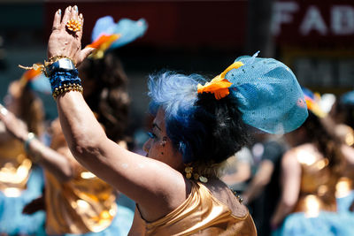 Close-up of woman with arms raised