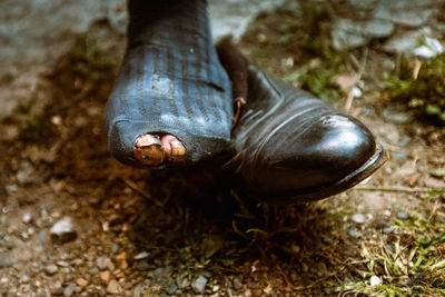 Close-up of human feet on field