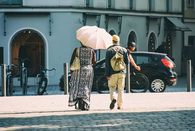 People walking on street in rain