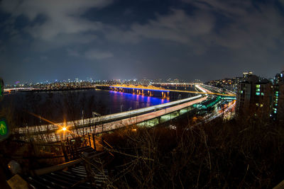 High angle view of illuminated bridge over river at night