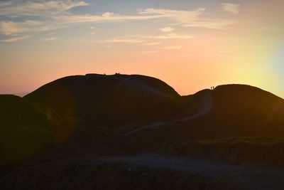 Scenic view of silhouette mountains against sky during sunset