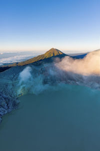 View of volcanic mountain against blue sky