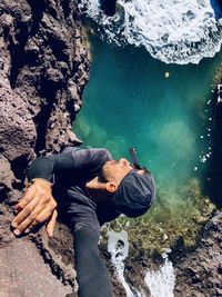 Low section of man standing on rock