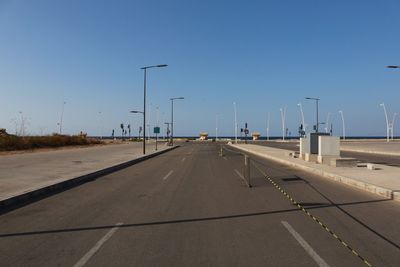 View of highway against clear blue sky