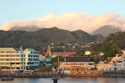 Townscape by mountains against sky