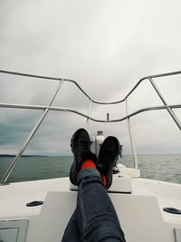 Low section of man in sea against sky