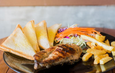 Close-up of burger and vegetables on table