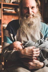 Portrait of man with father sitting at home