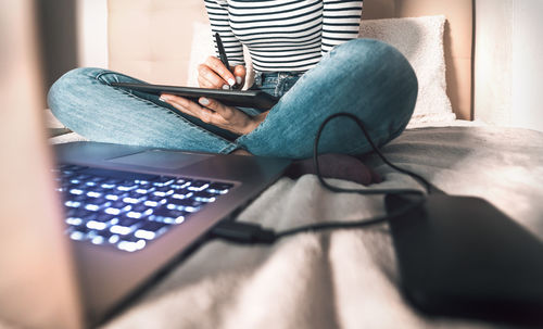 Midsection of woman using mobile phone