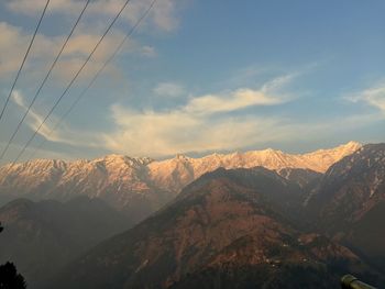 Scenic view of mountains against cloudy sky
