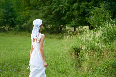 Midsection of woman standing on field