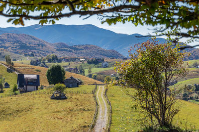 Scenic view of field and mountains against sky