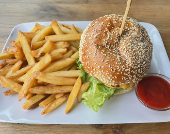 Close-up of burger and vegetables on table