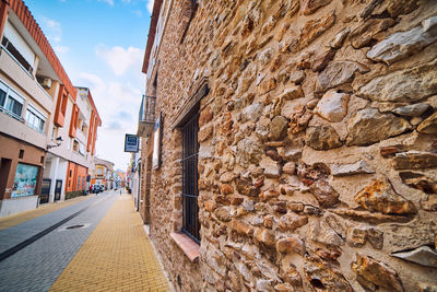 Narrow street amidst buildings against sky