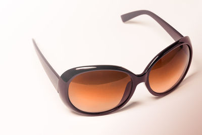 Close-up of sunglasses against white background