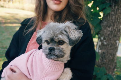 Midsection of woman holding dog