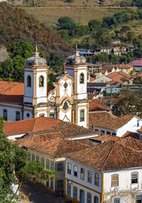 High angle view of trees and buildings in city